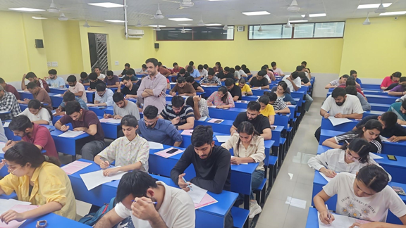 Aspirants appearing for a competitive examination in an examination hall.